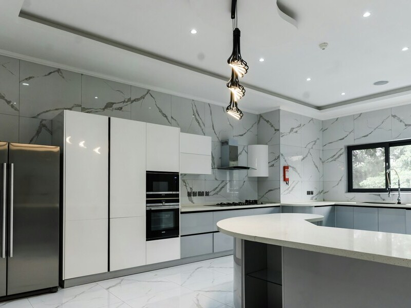 Bright, impeccably clean modern kitchen with marble finishes — Lady Moon Cleaning